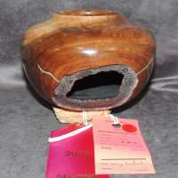 Larry-Linford-Walnut-Bowl-with-natural-hole-and-pyrography